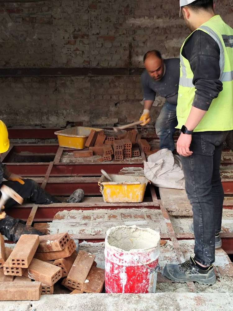 Bricks and mortar between the steel beams, building site in Istanbul