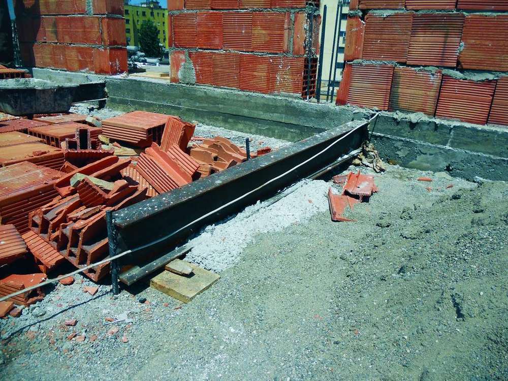 A steel beam laid along the roof edge
