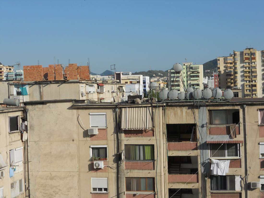 A new brick wall rises above the original roof parapet